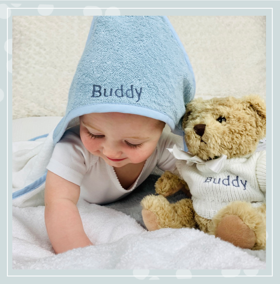 Baby with hooded towel and teddy bear